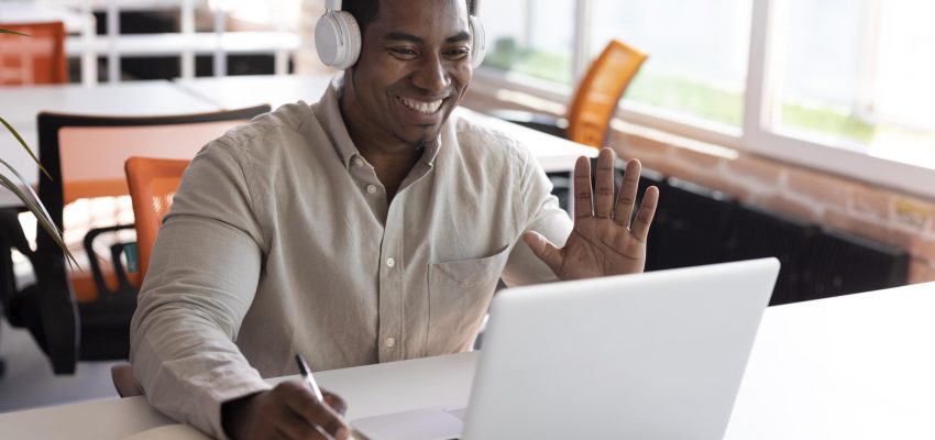 medium-shot-man-waving-laptop